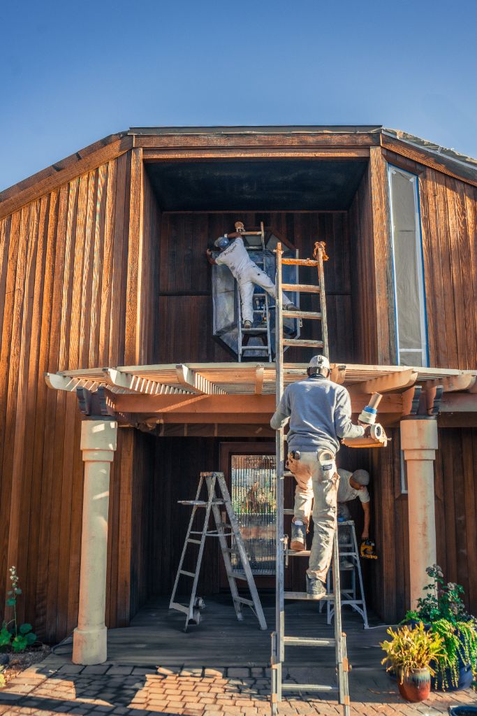 Three-man Milestone Painting crew working on NorCal estate exterior