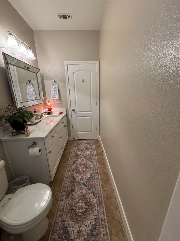 Bathroom before painting — plain beige walls before Milestone Painting Vacaville